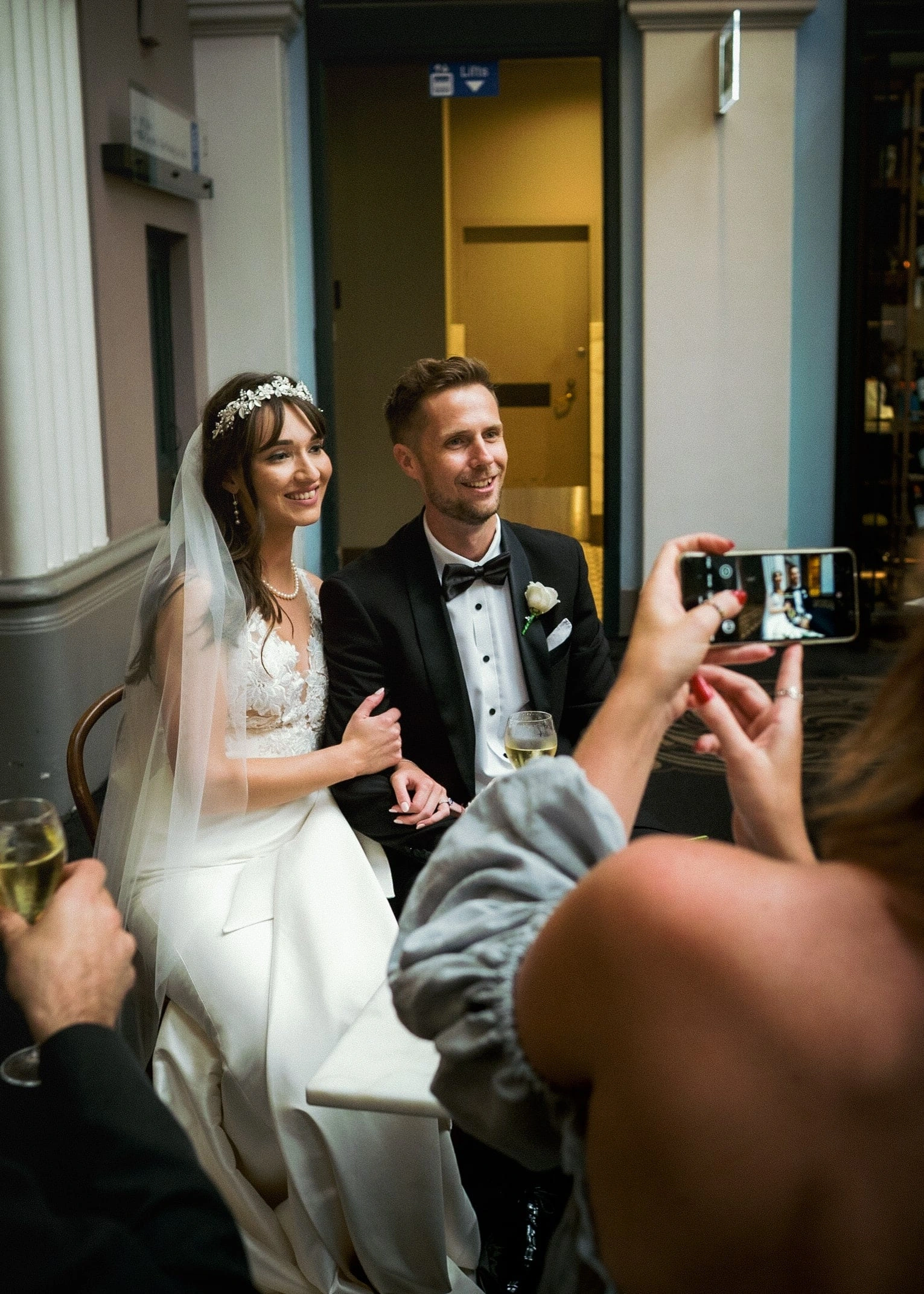 A guest photographs Lillie and Andrew together on their wedding day